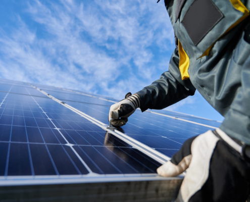 Worker holding a solar panel