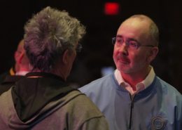Photo of UAW President Shawn Fain speaking with a UAW member.
