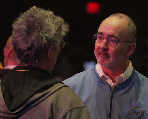 Photo of UAW President Shawn Fain speaking with a UAW member.