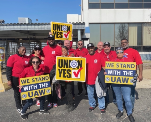 Photo of DP World workers in Trenton, MI, holding UAW signs.