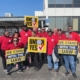Photo of DP World workers in Trenton, MI, holding UAW signs.