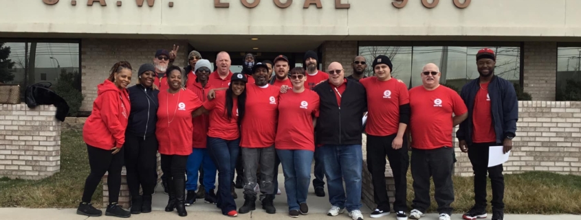 Photo of GNS workers in front of the UAW Local 900 union hall.
