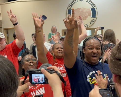 Photo of workers at the Volkswagen plant in Chattanooga, TN, celebrating after they voted overwhelmingly to join the UAW.