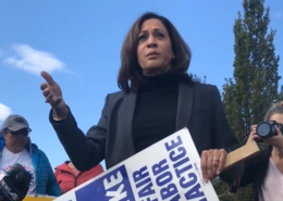 Photo of then-U.S. Senator Kamala Harris walking the picket line with UAW members on strike at General Motors.