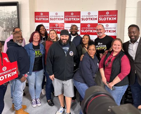 Photo of UAW members with Elissa Slotkin and UAW President Shawn Fain