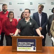 Photo of UAW Local 228 member JJ Jewell addressing the media during a Michigan House Democrats press conference introducing the May Day bill package to expand workers’ rights on May 1, 2025.
