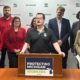 Photo of UAW Local 228 member JJ Jewell addressing the media during a Michigan House Democrats press conference introducing the May Day bill package to expand workers’ rights on May 1, 2025.