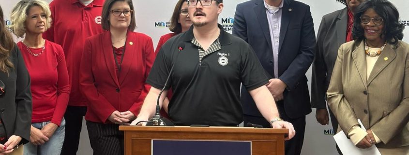 Photo of UAW Local 228 member JJ Jewell addressing the media during a Michigan House Democrats press conference introducing the May Day bill package to expand workers’ rights on May 1, 2025.