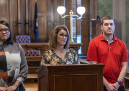 Local 6000 President Rachael Dickinson addresses the media on September 16, 2025, regarding a looming Michigan government shut down. Brandi Jenkins, Rehabilitation Counselor with Michigan Rehabilitation Services under the Department of Labor Economic Opportunity (LEO) is to the left of Dickinson and Ray Hesser, Child Protective Services (CPS) Worker, DHHS from Flint is on the right.
