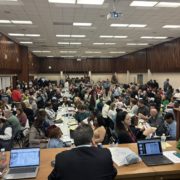 Members sitting inside meeting hall.