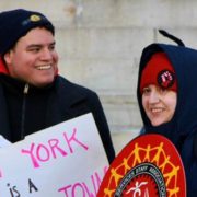 Association of Legal Advocates and Attorneys – UAW Local 2325- CAMBA IT Dept-Region 9A 15 UAW members rally outside in winter attire, in front of building, holding signs