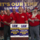 Screenshot of UAW Local 2093 bargaining chair Josh Jager, President Shawn Fain, Region 1D Director Steve Dawes, and the local bargaining committee during a UAW livestream announcing a tentative agreement at American Axle in Three Rivers, MI, on June 10, 2026.
