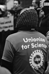 UAW Member wearing a shirt that says "Unionize for Science"